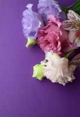 Beautiful flowers of eustoma (lisianthus) and alstroemeria. Bouquet of flowers on a lilac background. Copy space