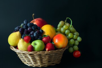 Fresh fruits in a basket on white and black background