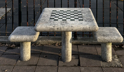 chessboard on a stone table in a public park (brooklyn new york city) chess board checkered squares...