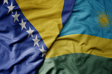 big waving national colorful flag of rwanda and national flag of bosnia and herzegovina.