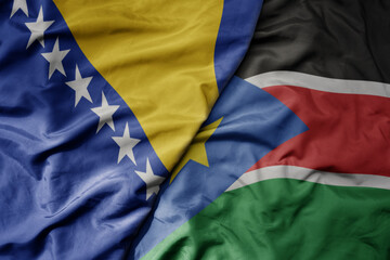 big waving national colorful flag of south sudan and national flag of bosnia and herzegovina.