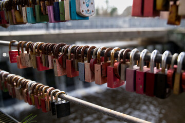 Engraved and marked locks hanging on the bridge railing. (Love locks, proof of love).in the...