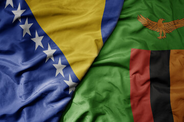 big waving national colorful flag of zambia and national flag of bosnia and herzegovina.