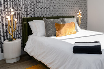 Black and white bedroom with gold accents and wallpaper