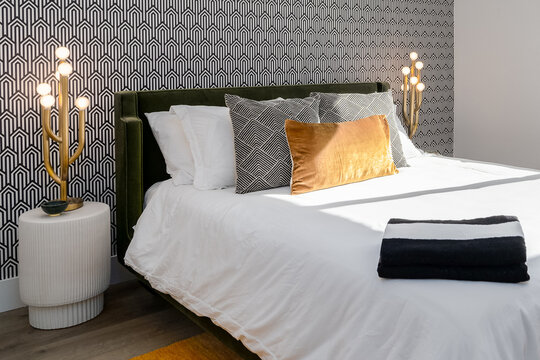 Black and white bedroom with gold accents and wallpaper