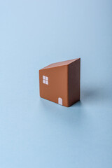 A small wooden house and keys as an idea for investing in your own home