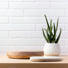 Round wooden board on table top and houseplant with a white brick wall. High quality photo