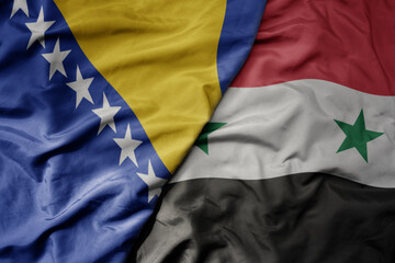 big waving national colorful flag of syria and national flag of bosnia and herzegovina.