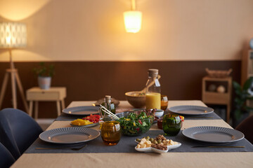 Background image of elegant dining room table with plates and dishes in cozy low light copy space