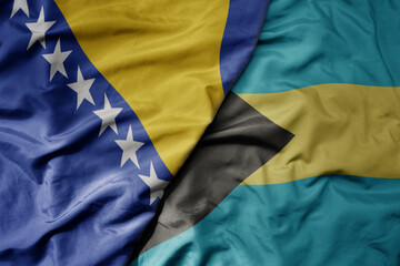 big waving national colorful flag of bahamas and national flag of bosnia and herzegovina.