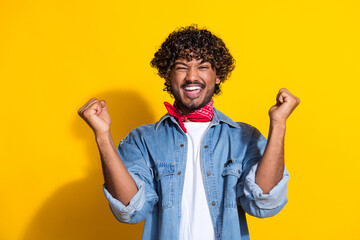 Photo portrait of attractive young man win lottery raise fists dressed stylish denim clothes red...