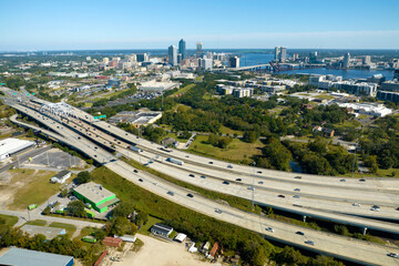 Aerial view of Jacksonville city with high office buildings and american freeway intersection with...