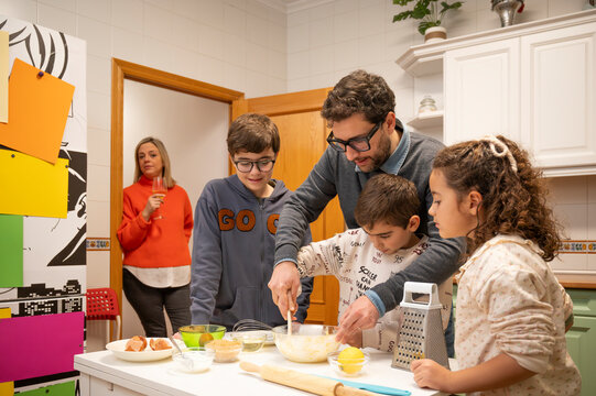 Family cooking together in a cozy home kitchen