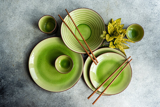 Elegant green ceramic tableware with chopsticks from above