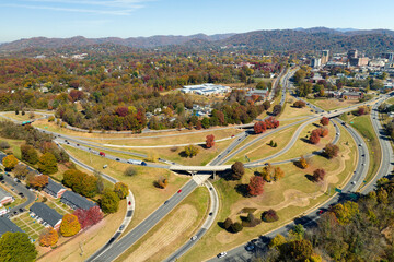 American freeway intersection in Asheville, North Carolina with fast driving cars and trucks in...