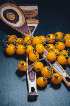 yellow cherry tomatoes on fancy serving spoons