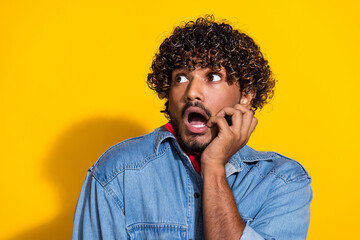 Photo portrait of attractive young man look scared empty space dressed stylish denim clothes red scarf isolated on yellow color background