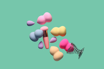 Flying different makeup sponges on green background