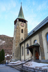 Clock tower of the pfarrkirche (parish church) of St. Mauritius in the village of Zermatt in the...