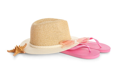 Stylish beach hat, flip flops and starfish on white background