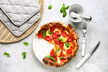 Plate with slices of tasty pizza Margarita on grey background