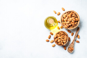 Almond nuts in wooden bowl at white background.