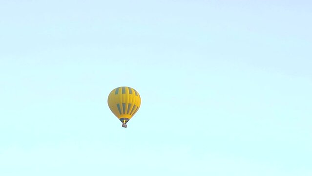 July 6, 2021 - West Bank, Luxor Egypt. Hot air balloons taking off at dawns first light and lofting their way across valley of the kings and other famous archeological sites.