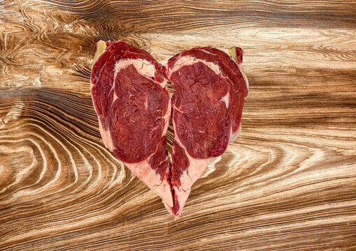 TWO BEEF ENTRECOT ON A WOODEN BACKGROUND