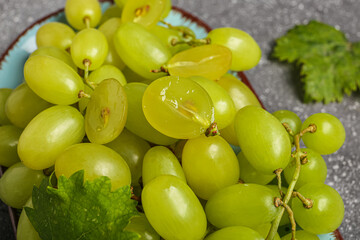Fresh green grapes on a plate, close up