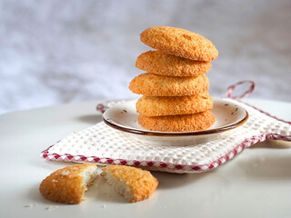 Coconut cookies in a plate on a white table