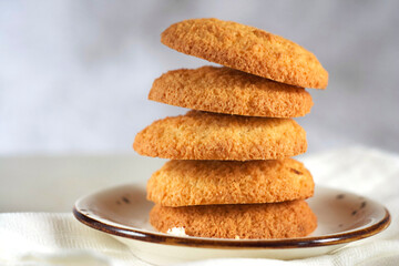 Coconut cookies in a plate on a white table