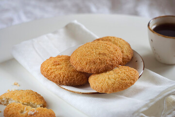 Coconut cookies in a plate on a white table