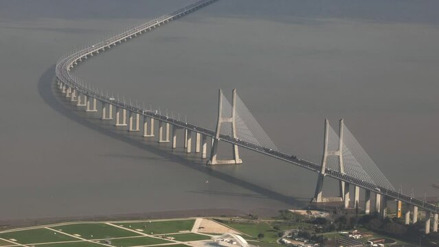 Vasco da Gama Bridge from above. 4K aerial video with this long cable-stayed bridge, impressive architecture and construction over Tagus river in Lisbon, Portugal.