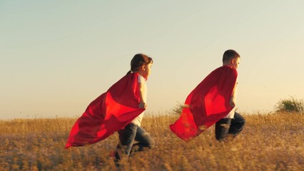happy dream little superheroes winners, happy children running red cloaks sunset, children fantasy...