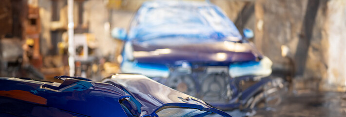 painting a car blue in the garage, repainting the body.