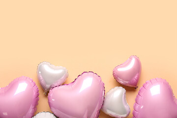 Heart shaped air balloons on beige background. Valentine's Day celebration
