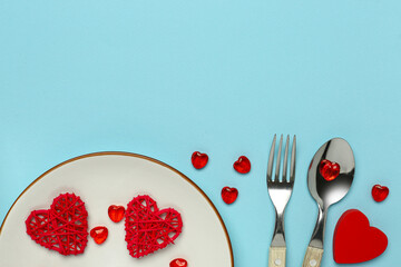 Beautiful table setting with hearts on blue background. Valentine's Day celebration