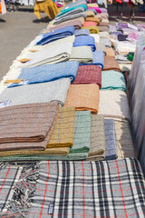 Wool scarves for sale at an outdoor market.