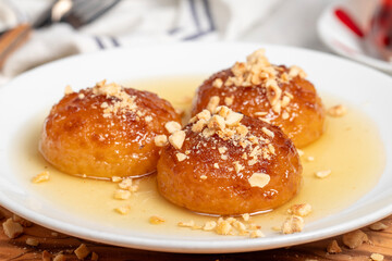 Kemalpasa dessert with milk. Turkish and Middle Eastern cuisine desserts. Ramadan meal. Kemalpaşa dessert on a wooden serving board