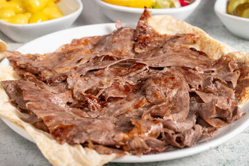 Meat doner kebab. Turkish and Middle Eastern cuisine flavors. Doner kebab on stone floor. Local name tabakta et döner