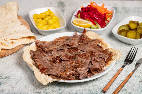 Meat doner kebab. Turkish and Middle Eastern cuisine flavors. Doner kebab on stone floor. Local name tabakta et d&ouml;ner
