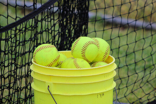 A 5 gallon bucket of used softballs
