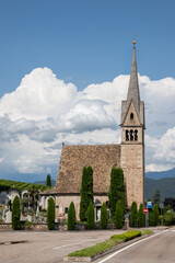 A small church on a background of clouds and blue sky