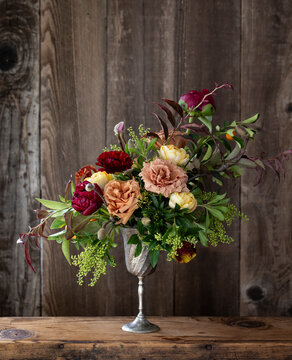 A bold vintage inspired bouquet with a rustic wood background