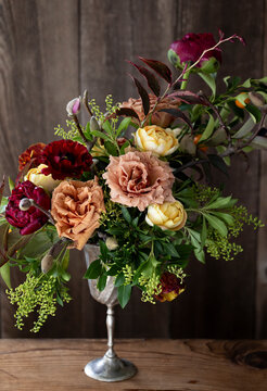 A bold vintage inspired bouquet with a rustic wood background