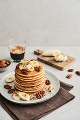 Plate of maple pecan pancakes with fresh bananas