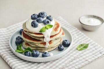 Plate blueberry pancakes with sour cream