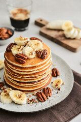 Plate of maple pecan pancakes with fresh bananas - 751803583