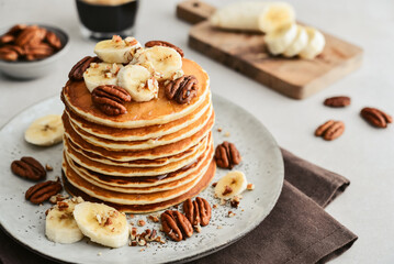 Plate of maple pecan pancakes with fresh bananas