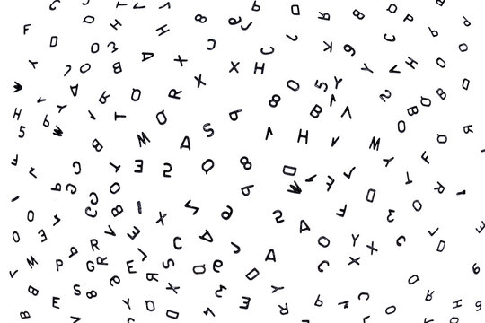 lots of different letters close-up, black small letters on white paper